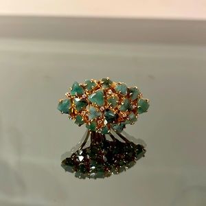 Exquisite emerald stone cut in a flowery setting